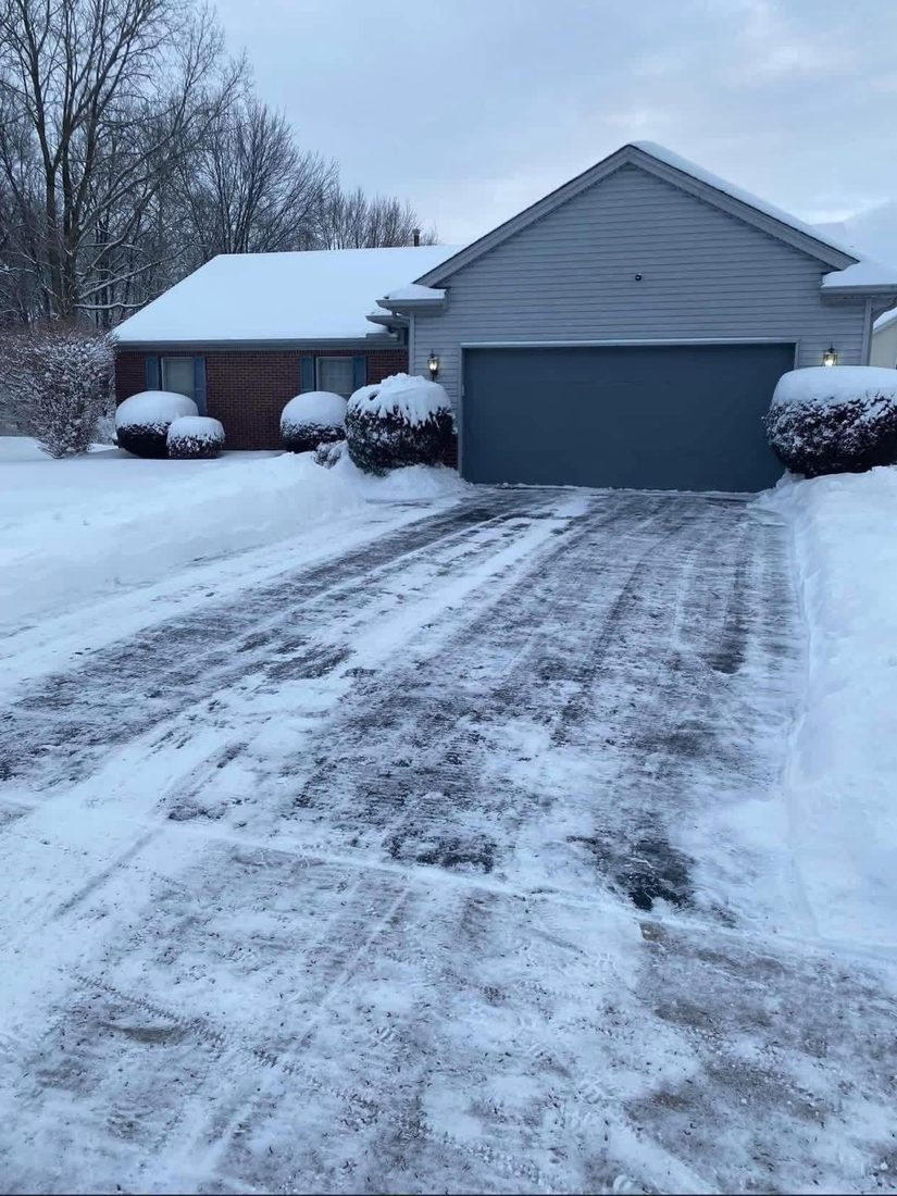 Plowed driveway with a clear path to the door after snow