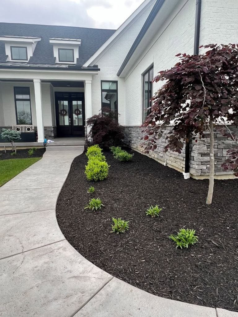 Red-mulch beds freshening up a front yard