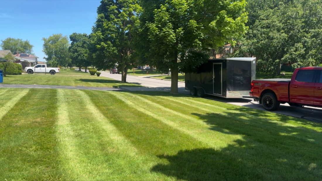 Freshly mowed lawn with the crew's truck on site